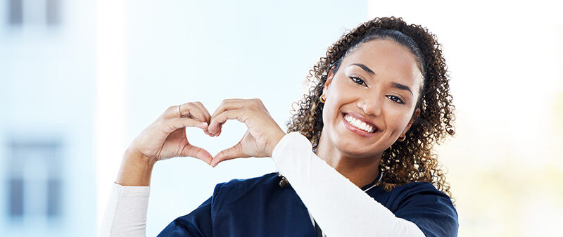 Doctor, portrait or heart hands in hospital wellness, medicine trust or medical support in life insurance, help or vote. Smile, happy or nurse with love gesture in healthcare, emoji or woman security